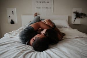 Cupple cuddling on the bed