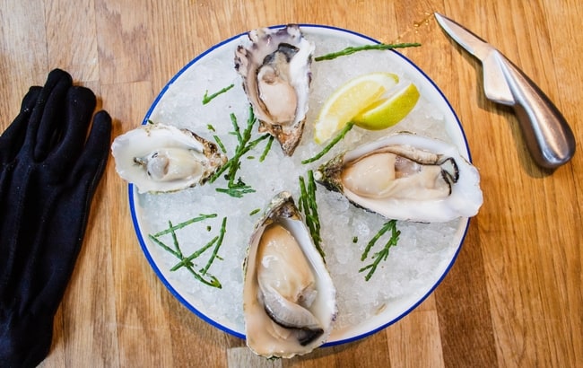 Oysters, ice and lemon on a plate