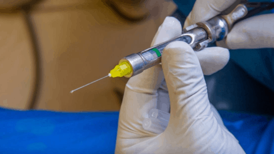 hand holding a syringe 